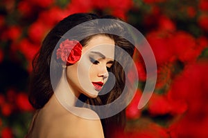 Outdoors portrait of Natural Beauty woman in red roses. Sensual