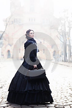 Outdoors portrait of a victorian lady in black