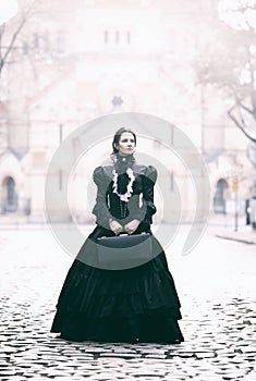 Outdoors portrait of a victorian lady in black