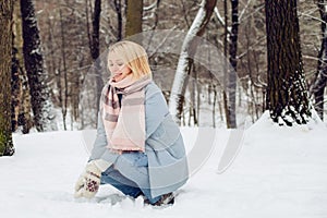 Outdoors portrait of young beautiful woman having fun in winter