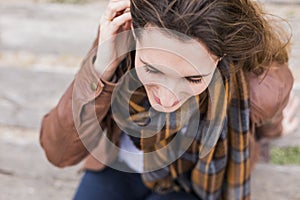 Outdoors portrait of a young woman with brown jacket photo