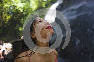 Outdoors Summer holidays lifestyle portrait of young happy and beautiful Asian Chinese woman in bikini enjoying at tropical