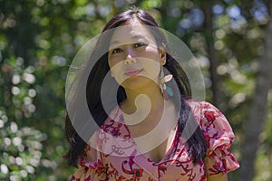 Outdoors Summer lifestyle portrait of young beautiful and happy Asian Chinese woman in elegant dress walking tranquil and cheerful