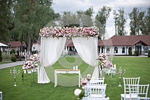 Outdoors wedding decoration with flower bouquets, candles and ga