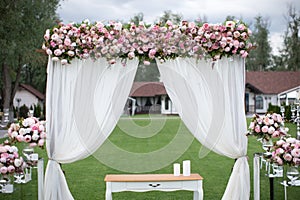 Outdoors wedding decoration with flower bouquets, candles and ga