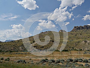 Outdoors in Wyoming, with buttes and rock formations on the mountaintops