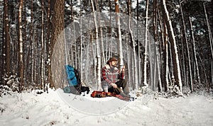 Outdoorsman drinking tea, winter forest photo