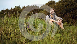 Outdoorsman sitting grass enjoying nature