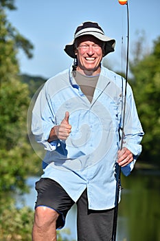 Outdoorsman With Thumbs Up With Fishing Rod Fishing photo