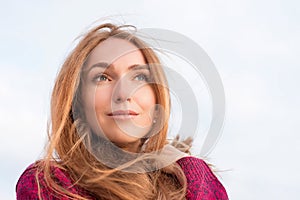 Outdor portrait of serene beautiful woman with long hair flutter