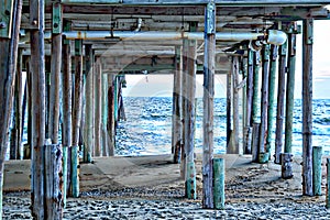 The Outer Banks beach pier has an impressive underbelly of solid wood pilings