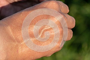 the outer side of the male palm. Muscles and veins of the arm close-up. Sweaty hand after a workout