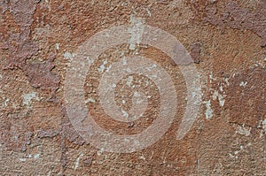 The outer surface of the wall of an old building. Abstract background. The texture of the dilapidated multilayer