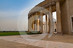 Outer view of one of the colonnades of the Basilica of Our Lady of Peace with the setting sun to the west