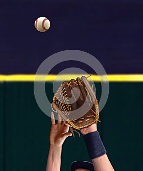 Outfielder hand catching baseball