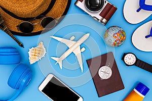 Outfit and accessories of traveler on blue background with copy space, Travel concept, Overhead view of Traveler`s accessories,