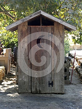 Outhouse with crescent moon door