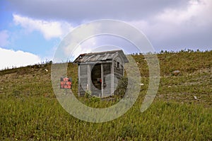 Outhouse on a hillside photo