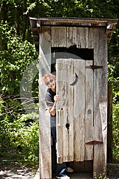 Outhouse with woman peeking out