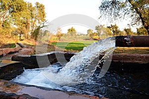 Outlet of a tube well to a temporary reservoir in a small village of Pakistan