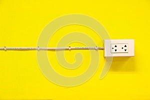 The outlet on yellow wall