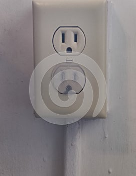 Outlets with one covered with a child safety plug and the other not covered