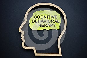 Outline of the head and inscription Cognitive behavioral therapy CBT on a piece of paper.