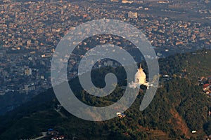 the outlook of Peace Pagoda in hill area with the townscape of Pokhara