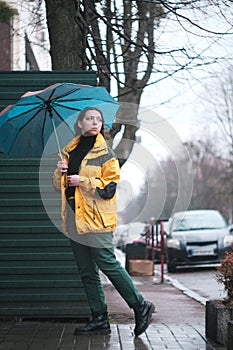 Outoor picture of young woman with umbrella