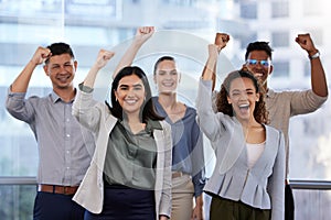 We outperformed, it paid off. Portrait of a group of young businesspeople cheering in a modern office.