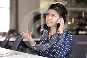 Outraged Indian female employee talking by phone