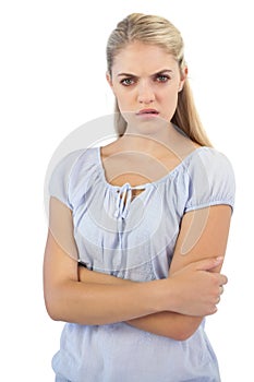 Outraged blonde woman with arms crossed