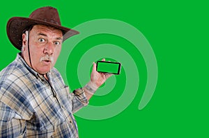 Outraged farmer with chroma key screen mobile phone.