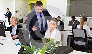 Outraged manager with frustrated girl in office