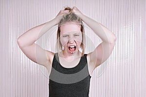 Outraged young woman having a temper tantrum shouting and screaming