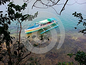 Outrigger boat moored near north shore of Virgin Island, Hundreed Islands National Park, Alaminos, Philippinnes