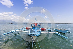 Outrigger boat moored at wharf