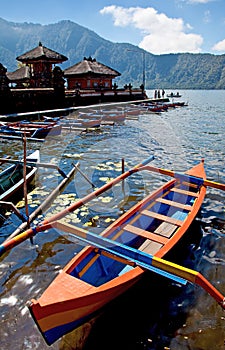 Outrigger boats at Ulun Danau temple at Lake Beratan in Bedugul, Bali, indonesia.