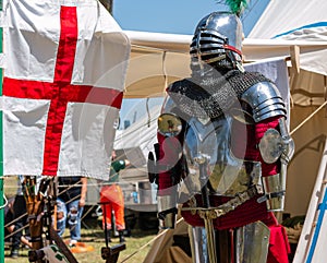 outside a camp tent of a medieval knight plate armor on a mannequin