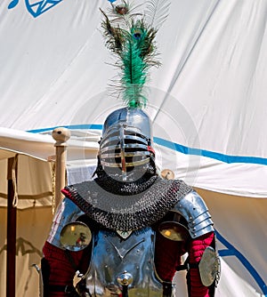 outside a camp tent of a medieval knight plate armor on a mannequin