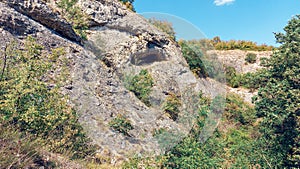 Outside of a cave in the mountain.