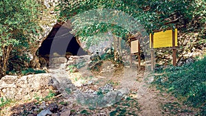 Outside of a cave in the mountain.