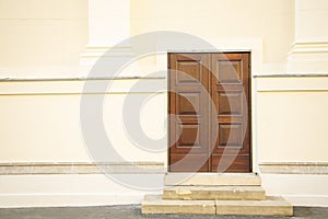 Outside exterior wall with old decay stairs and closed wooden door simple background side of building with copy space for your