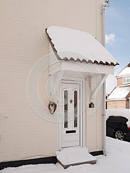 Outside of house with snow on front porch covered