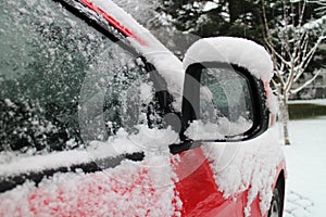 Outside mirror of snow covered automobile