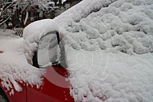 Outside mirror of snow covered automobile