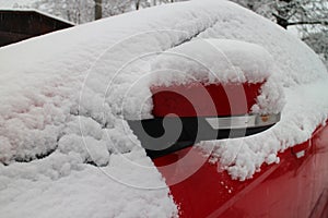 Outside mirror of snow covered automobile