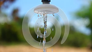 Outside shower with running water bokeh background