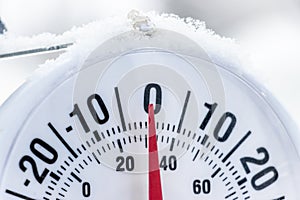 Outside thermometer showing lightly under frozen temperature, zero Celcius degrees or minus 32 Farhenheit photo