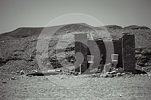 Outside toilet in desert, outhouse, black and white